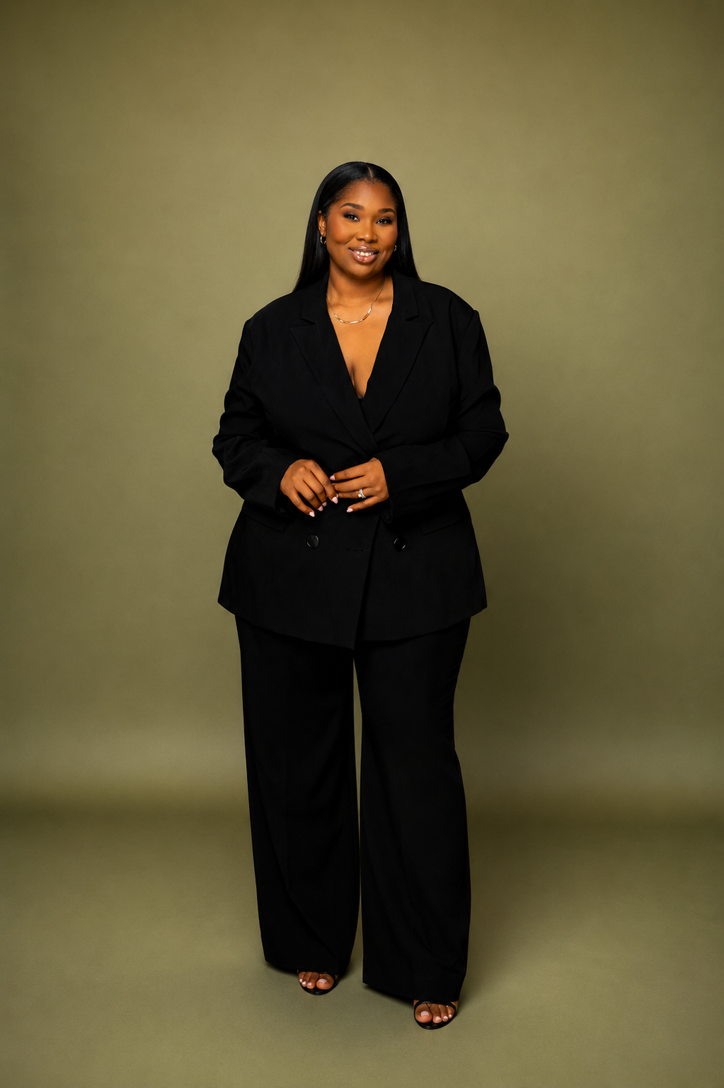 Full-length portrait of Jasmine Howell in a black suit